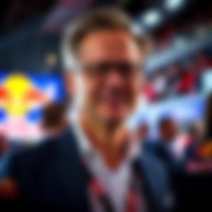 Mark Mateschitz attending a Red Bull sports event with vibrant branding in the background